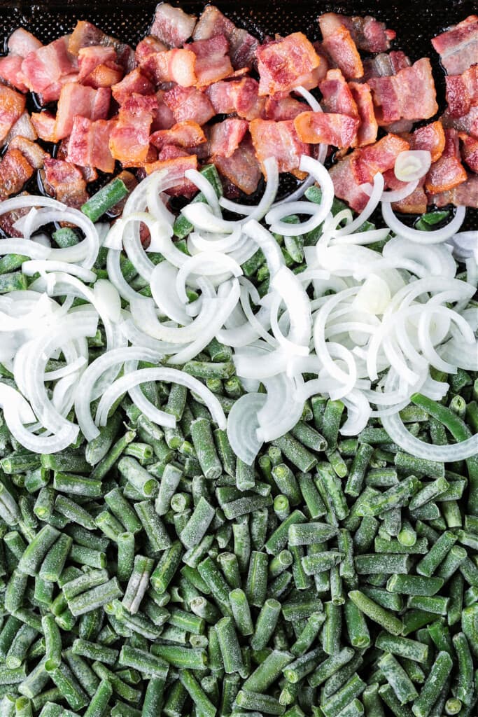 bacon, onions and frozen green beans on a sheet pan