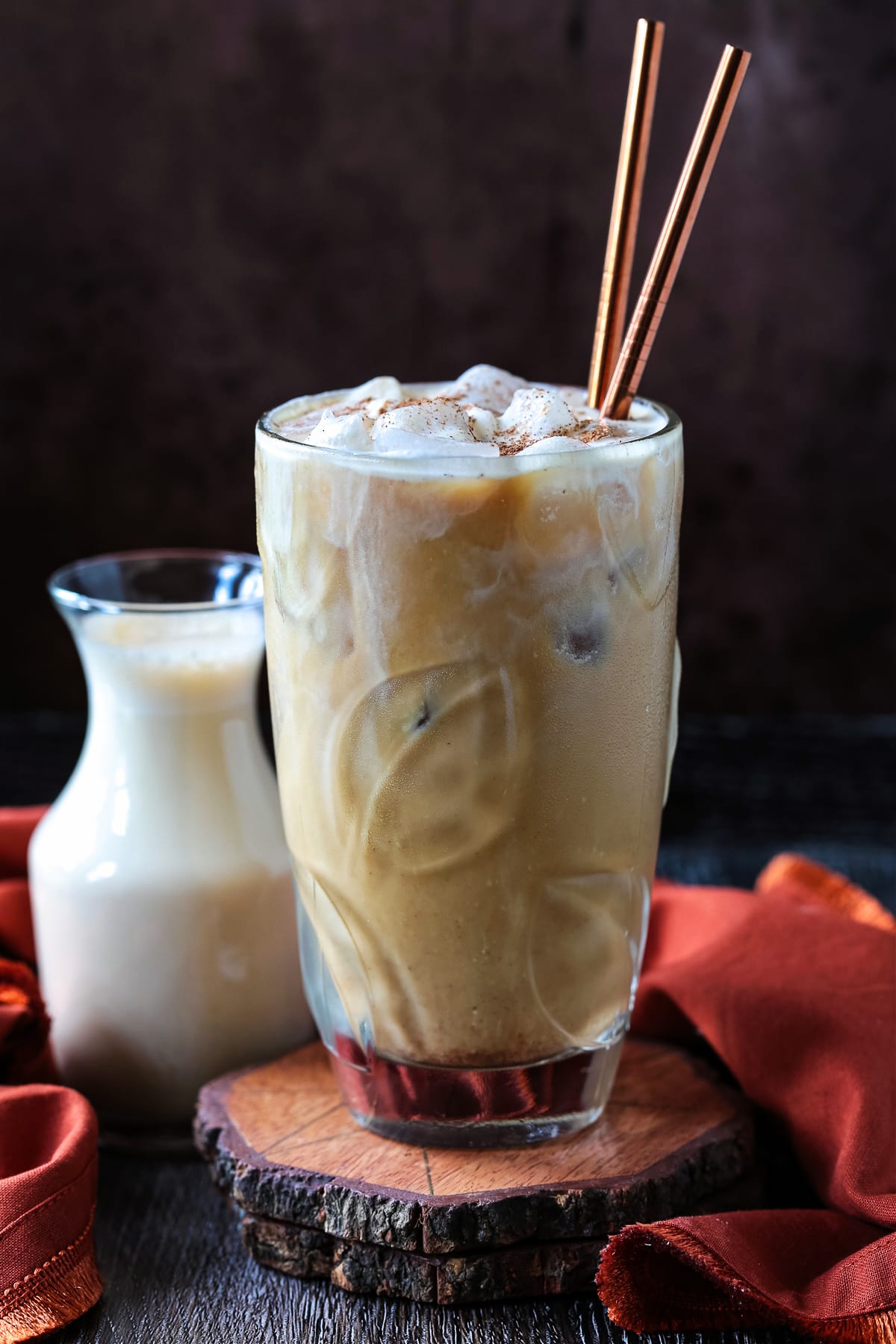 Elevate your coffee at home with homemade Pumpkin Cream Cold Brew! Even better than ordering out, made with real pumpkin and warm spices! pumpkin cream cold brew in iced coffee drink with straws