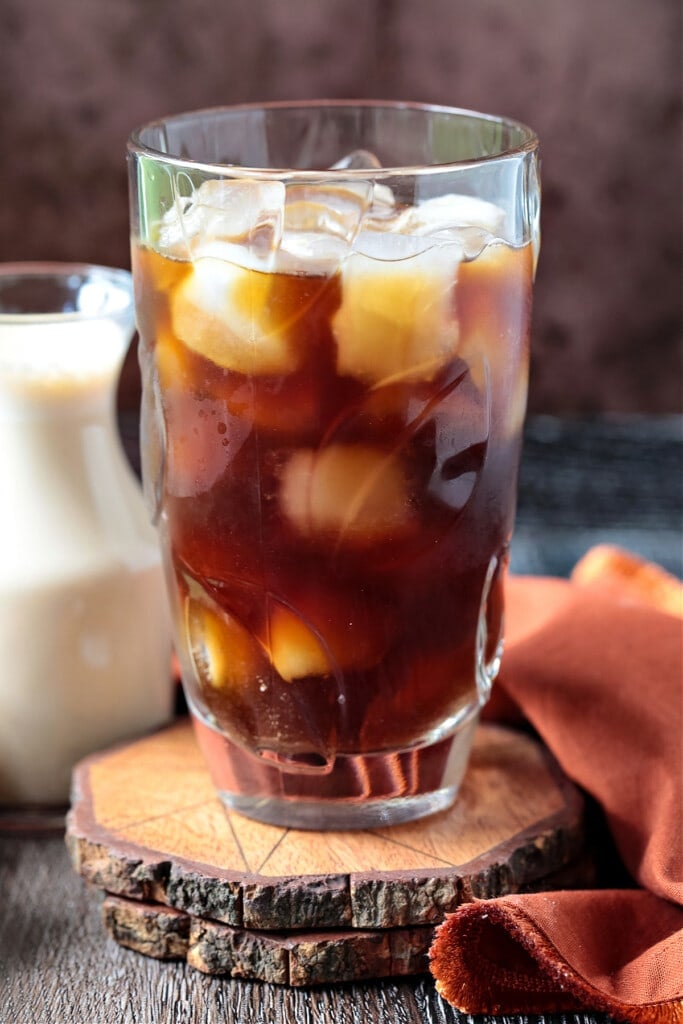 Elevate your coffee at home with homemade Pumpkin Cream Cold Brew! Even better than ordering out, made with real pumpkin and warm spices! coffee in tall glass with ice