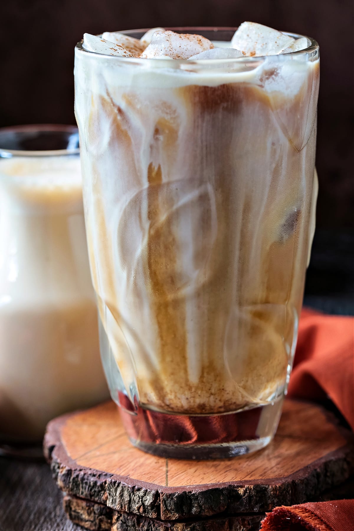 iced coffee with creamer poured in a tall glass