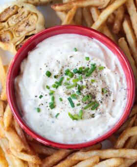 garlic aioli in a red bowl with french fries