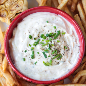 garlic aioli in a red bowl with french fries