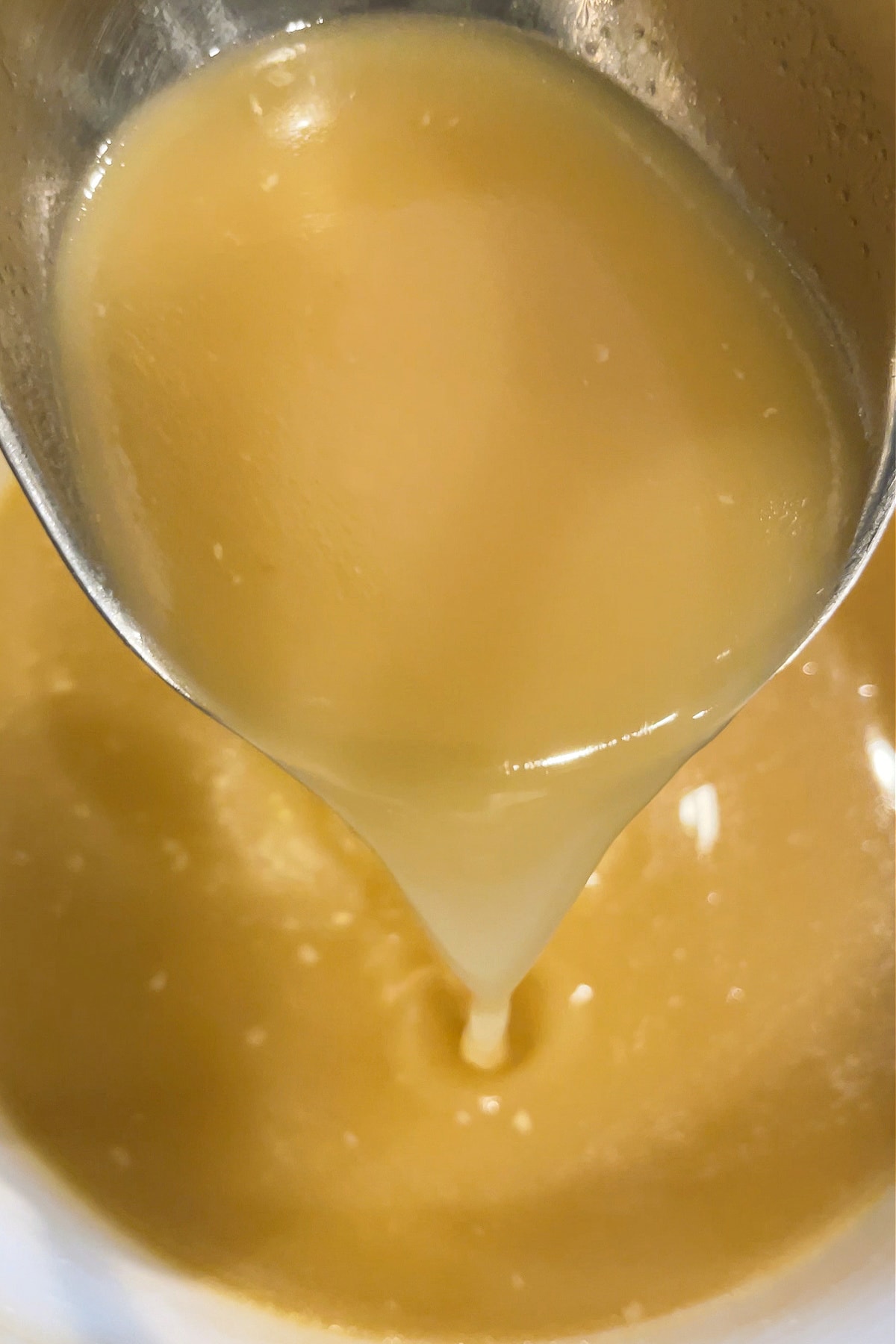 Rotisserie Chicken Stock is so easy to make with leftover rotisserie chicken bones! Use this hearty chicken stock in soups, stews and more! ladle witch chicken stock