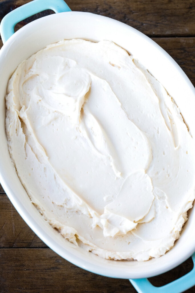 This Caramel Apple Dip is perfect for parties! An easy dessert recipe with the flavors of a nutty caramel apple and sweetened cream cheese. cream cheese layered in a dish