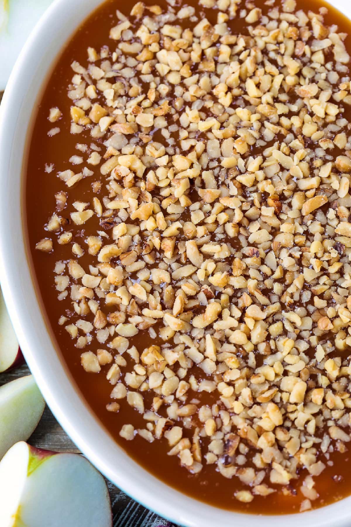 dip with caramel and sweetened cream cheese topped with chopped nuts