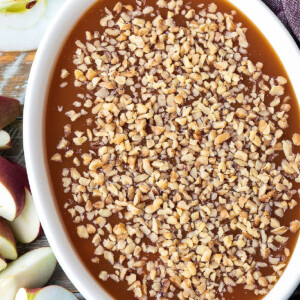 caramel apple dip with chopped walnuts on top