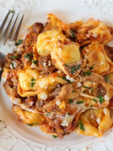 cheese tortellini with ground beef and cheese on a plate with fork