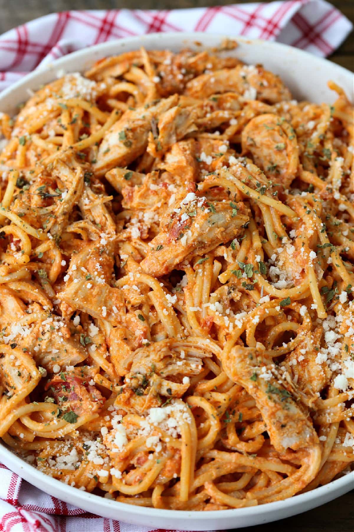 chicken spaghetti in white bowl on a napkin