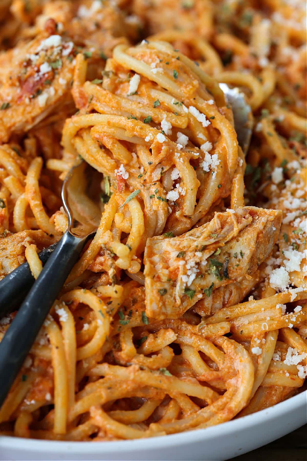 spaghetti with chicken wrapped around a fork