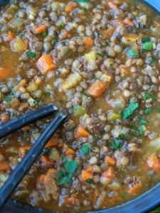 spoons in a bowl of lentil soup