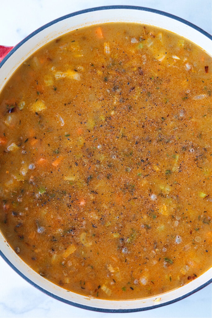 This cozy French Lentil Soup is ready to serve in just 30 minutes. Enjoy this veggie-packed, easy to make soup and night of the week! broth and vegetables in soup pot