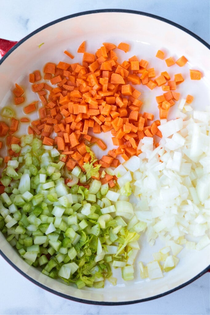 This cozy French Lentil Soup is ready to serve in just 30 minutes. Enjoy this veggie-packed, easy to make soup and night of the week! carrots, onions and celery in soup pot