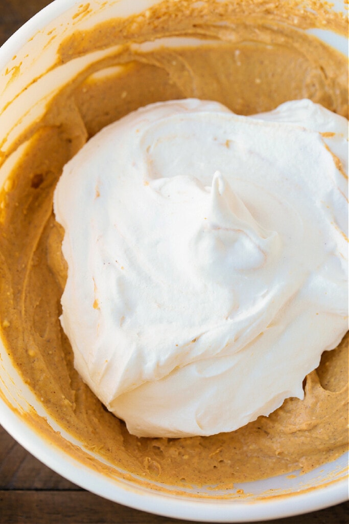 whipped topping in a bowl with pumpkin filling