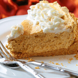 slice of no bake pumpkin pie on white plate with two forks