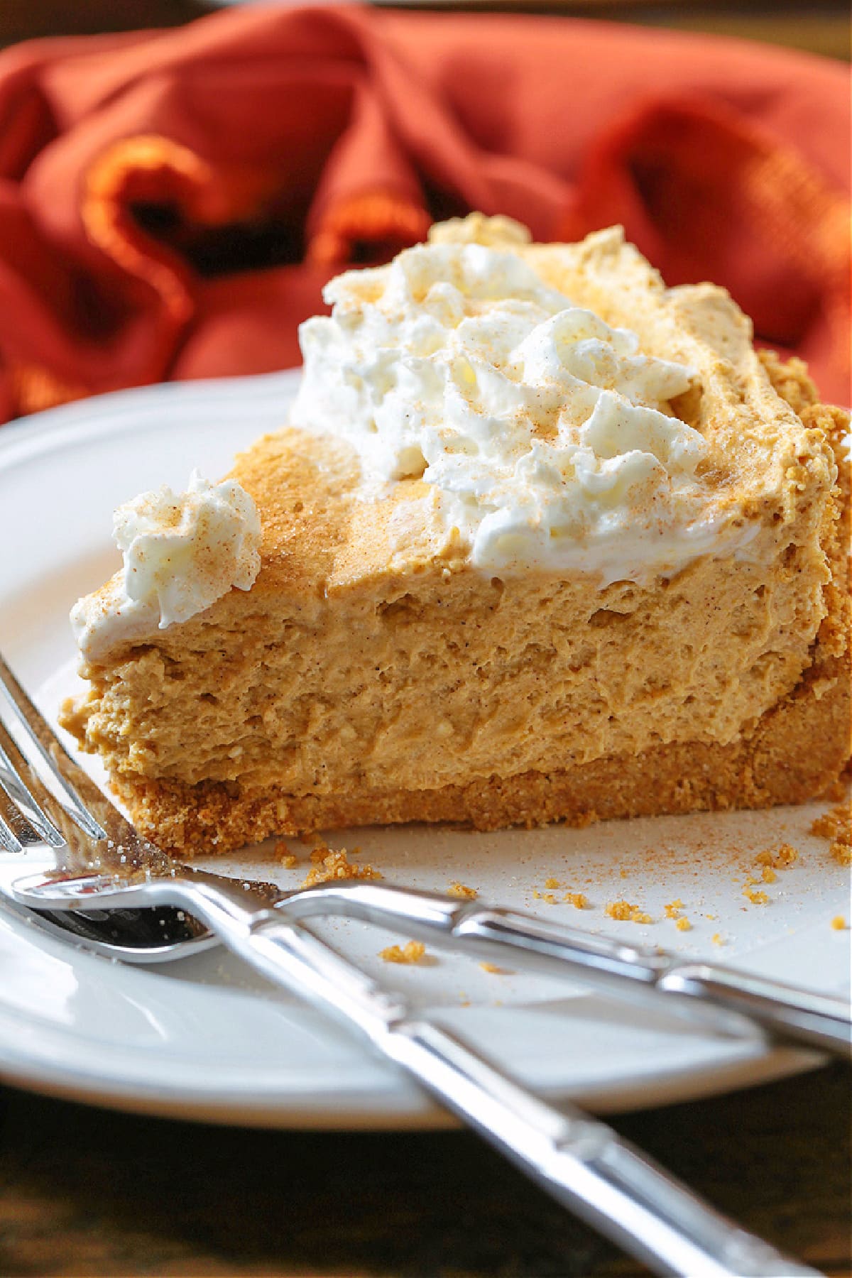 slice of no bake pumpkin pie on white plate with two forks