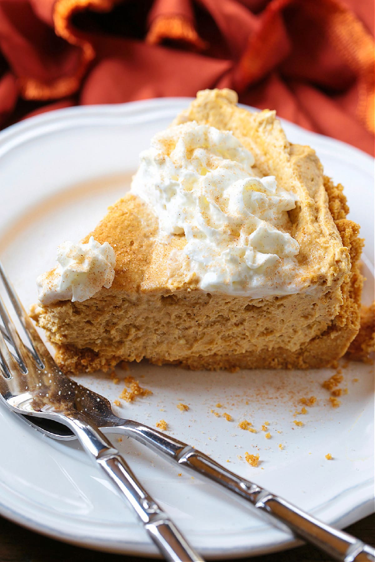 slice of no bake pumpkin pie on plate with forks