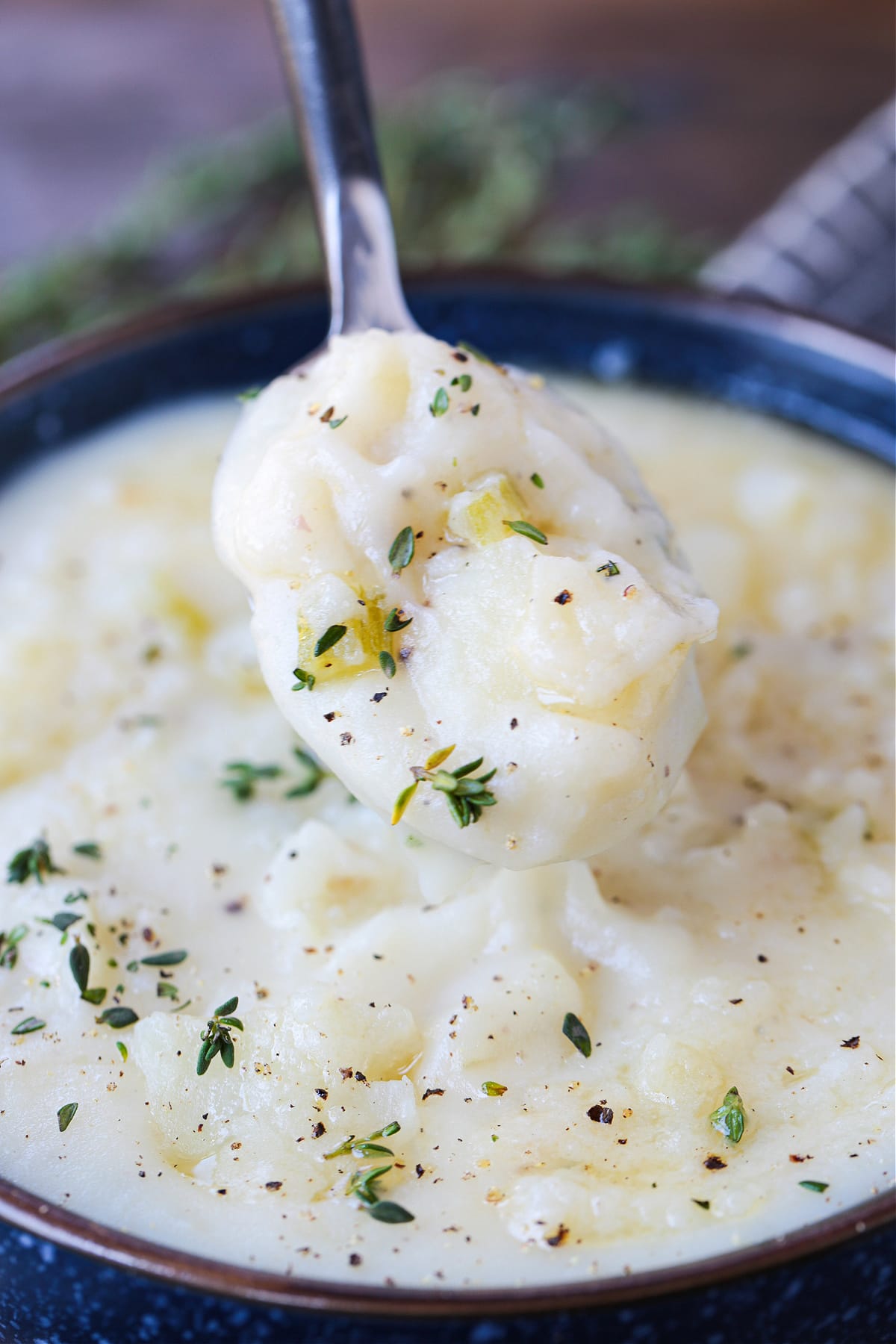 a spoonful of potato soup over a bowlThis Old Fashioned Potato Soup is so hearty, creamy and comforting. Easy to make with just a few ingredients, this comfort food soup recipe will warm you up on chilly days.