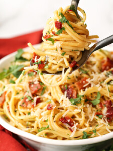 pasta carbonara twirled on a fork and spoon