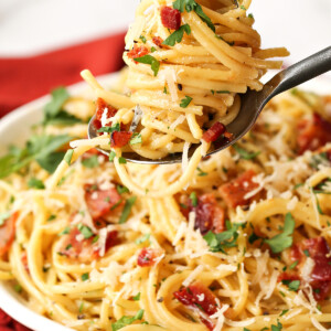 pasta carbonara twirled on a fork and spoon