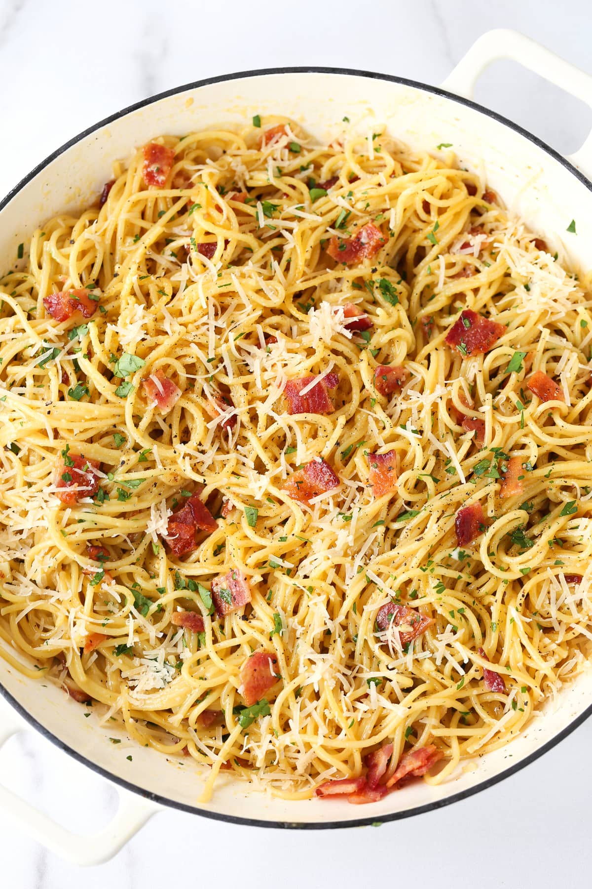 Enjoy the deliciousness of this simple Pasta Carbonara any time of the week! A 15 minute pasta dish that's oozing with comfort food feels. spaghetti carbonara in pot from the top