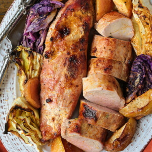 pork tenderloins on a bed of apples and cabbage