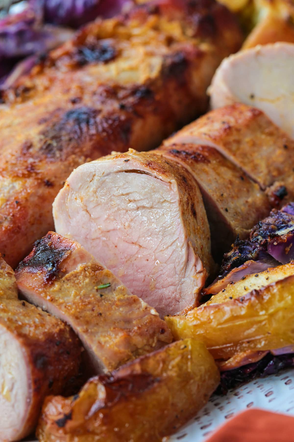 slice of pork with a whole tenderloin in the background