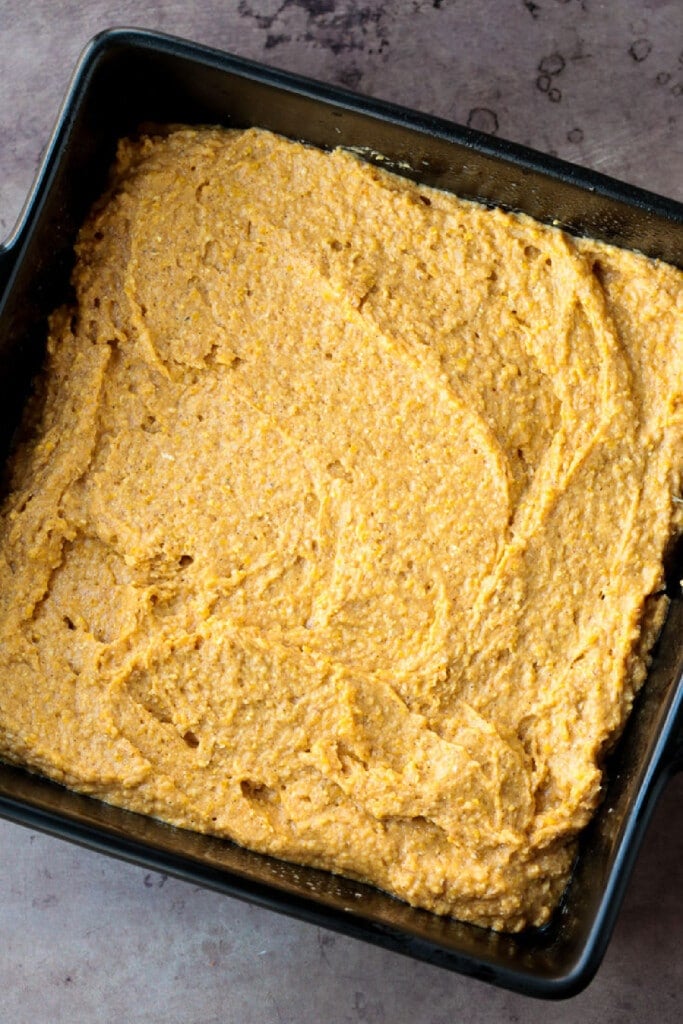 This Pumpkin Cornbread is giving all the fall vibes! Insanely moist and flavorful, with the perfect amount of pumpkin spice flavor! cornbread batter in a baking dish before baking