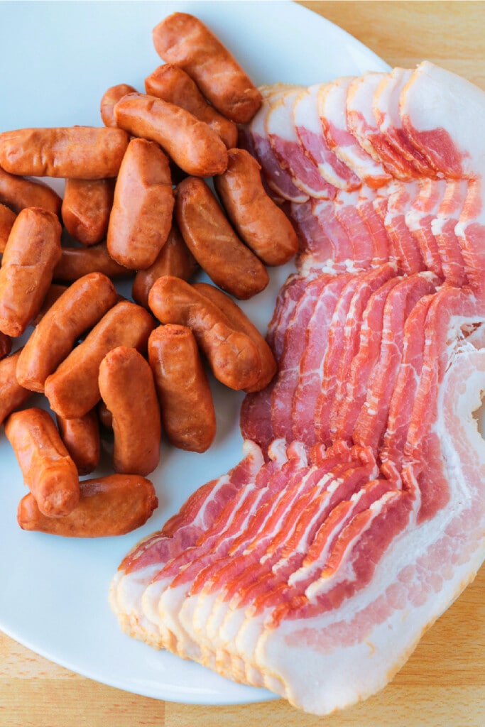 Bacon Wrapped Smokies are an addicting one-bite appetizer that everyone loves! Perfect for game days, parties and holidays! ingredients for bacon wrapped mini hot dogs