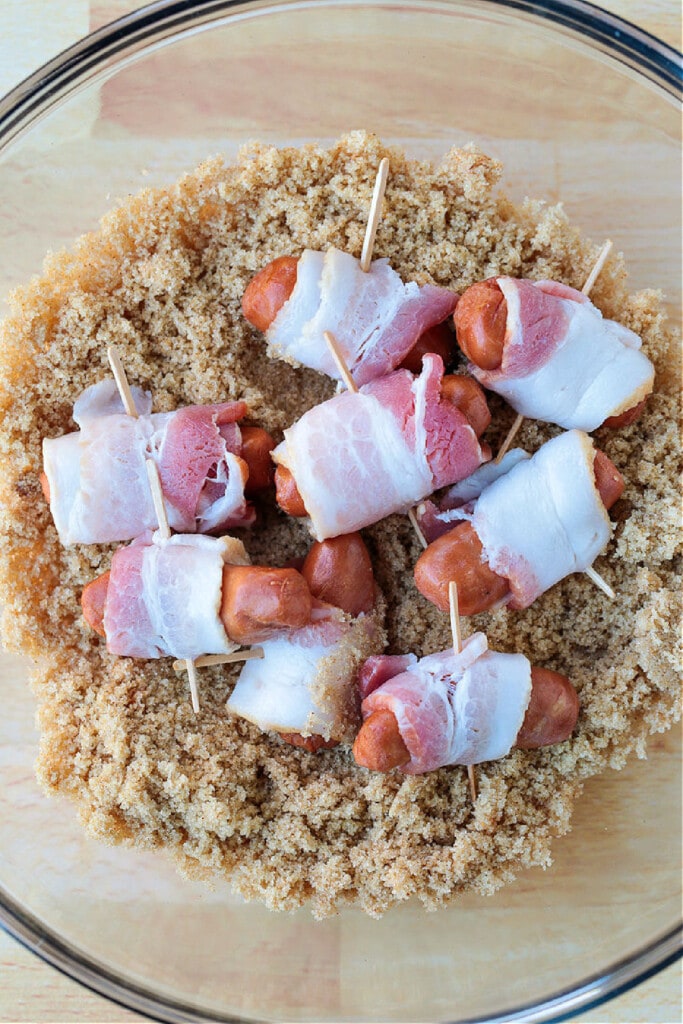 bacon wrapped smokies in bowl with brown sugar