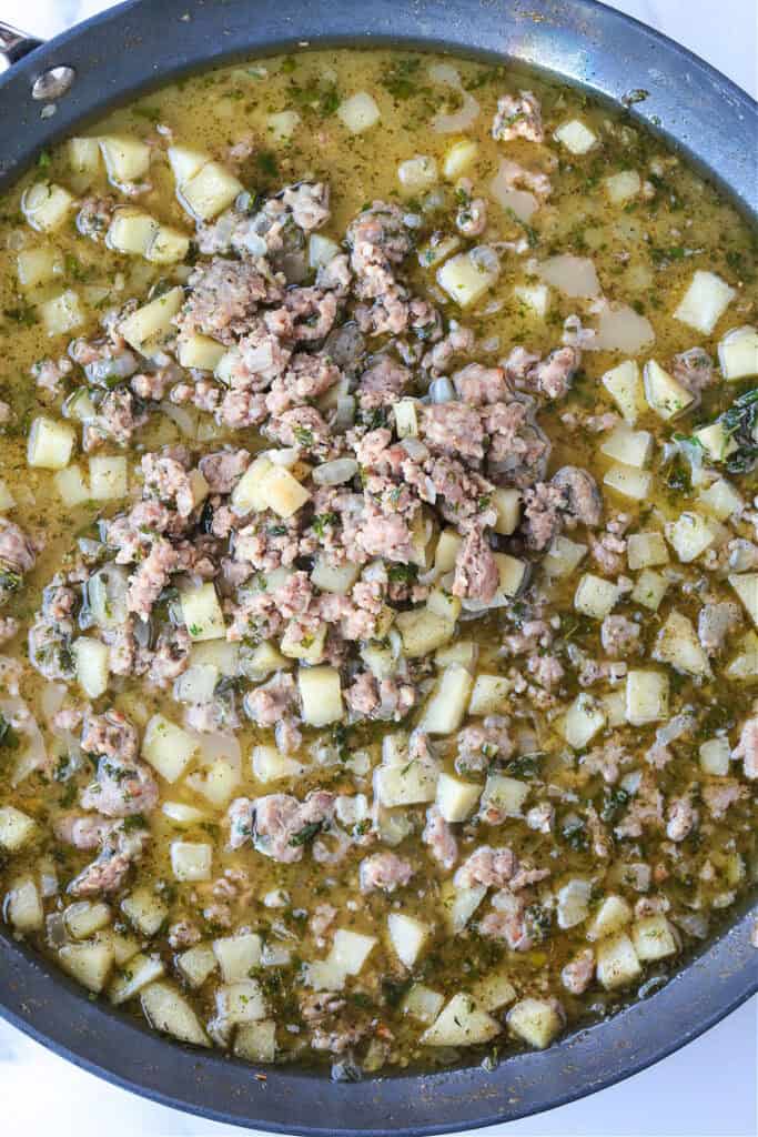 Our Sausage Stuffing Recipe is a favorite at Thanksgiving. Tons of sausage, sweet apples and buttery, toasted bread. We crave it all year! sausage, onions and apples in broth