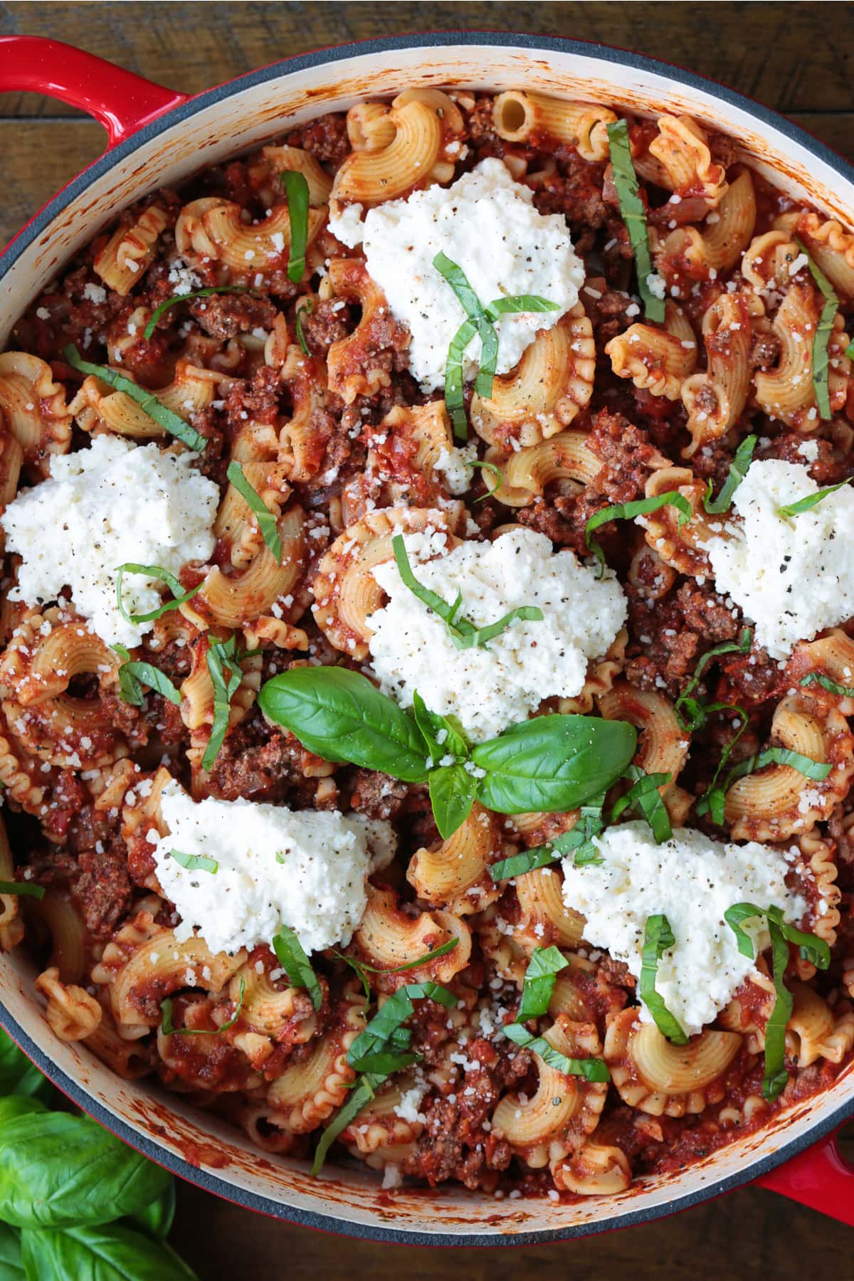 pan of deconstructed lasagna with dollops of ricotta cheese on top