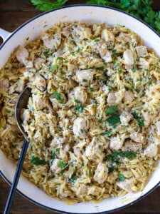 orzo and chicken in white skillet with spoon