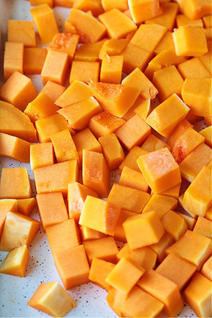 This simple Roasted Butternut Squash is so full of flavor. An easy side dish that goes with just about any dinner, especially a holiday meal! diced butternut squash on cutting board