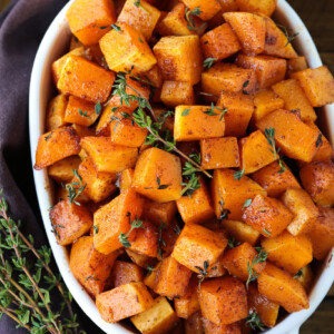 diced butternut squash in baking dish with thyme