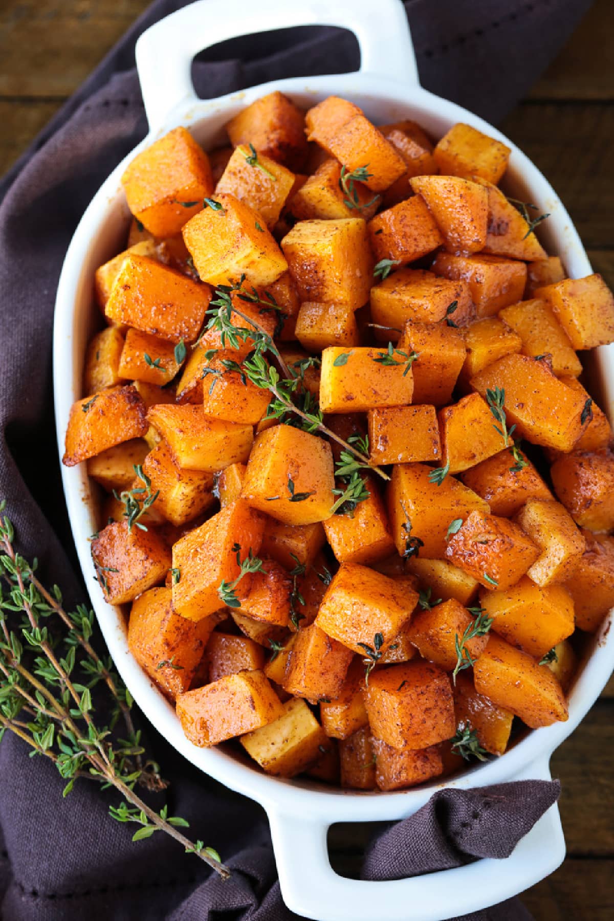diced butternut squash in baking dish with thyme