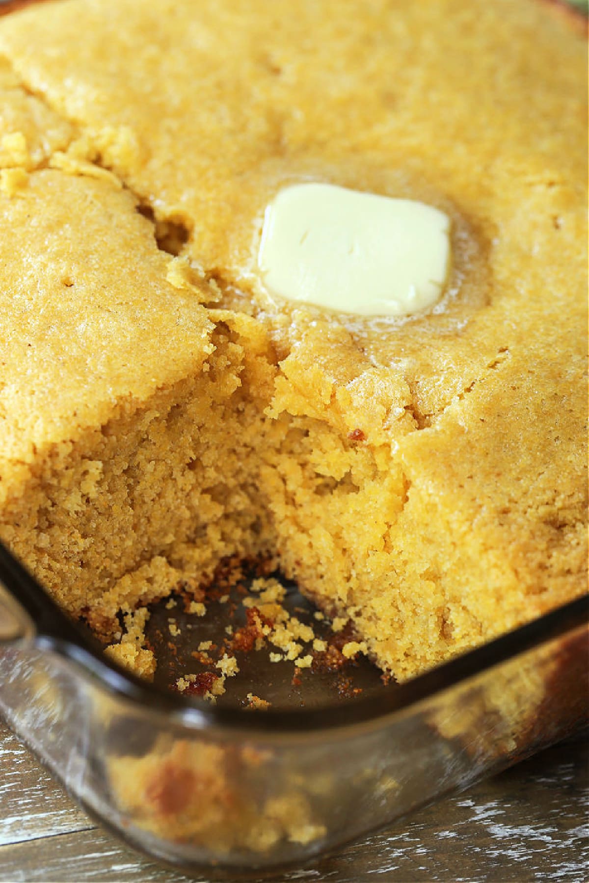 Sweet Cornbread is so moist and addicting. This sweet cornbread recipe is an easy side dish for chili, pulled pork or a holiday ham dinner! cornbread in a baking dish with a square cute out