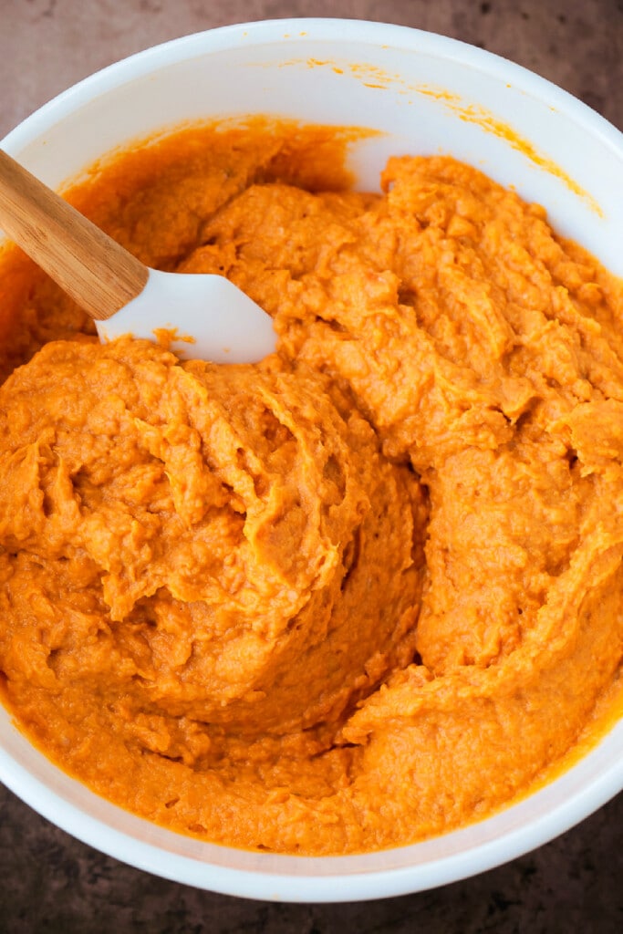 Our Sweet Potato Souffle is light and fluffy with a sweet, nutty streusel topping! A make ahead side dish for all of your holiday dinners! whipped sweet potato filling for souffle