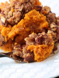 sweet potato souffle in white plate with fork