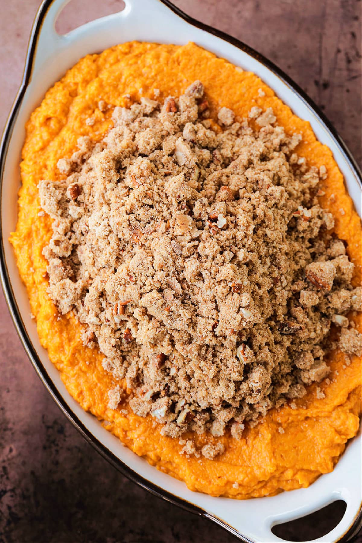 Our Sweet Potato Souffle is light and fluffy with a sweet, nutty streusel topping! A make ahead side dish for all of your holiday dinners! sweet potato souffle before baking