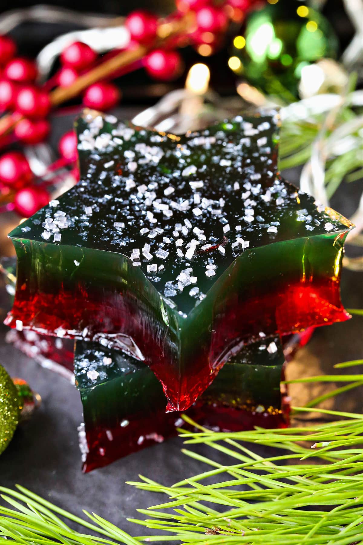 This Christmas Jello Dessert is going to be the star of the party! This festive dessert is made with a splash of real bubbly champagne! jello stars in Christmas colors