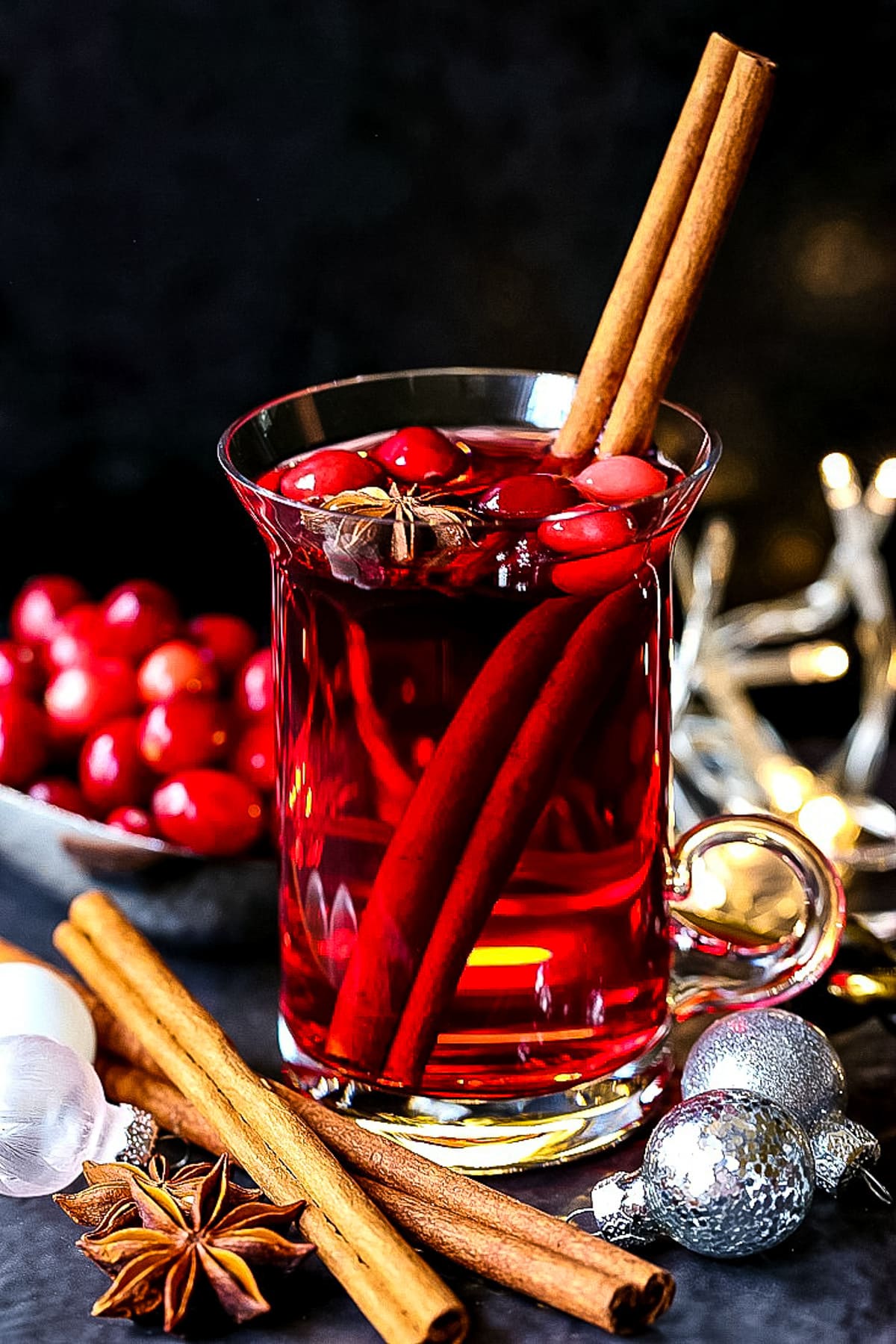 christmas punch in glass mug with cinnamon stick garnish