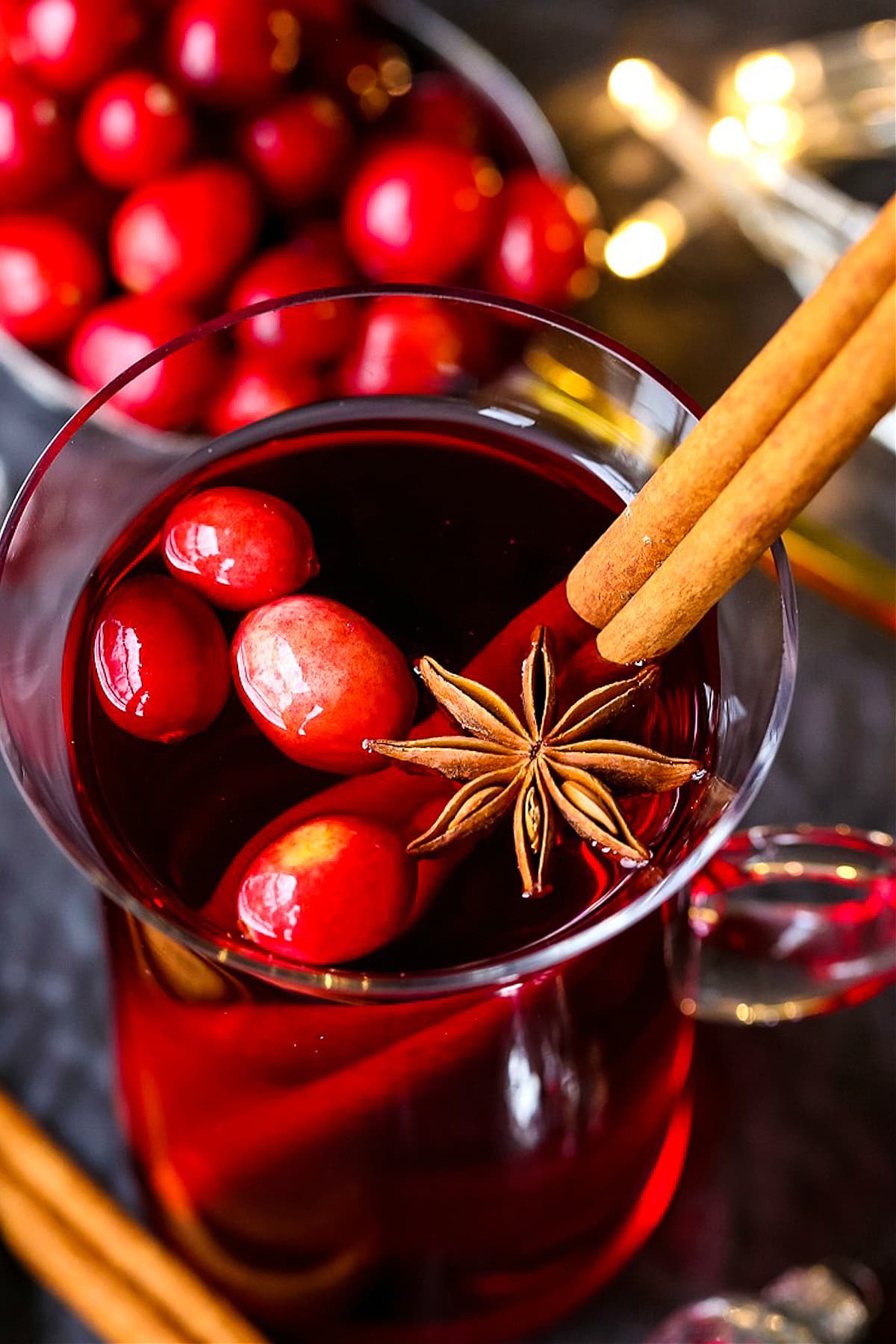 slow cooker punch in mug with garnish in the background