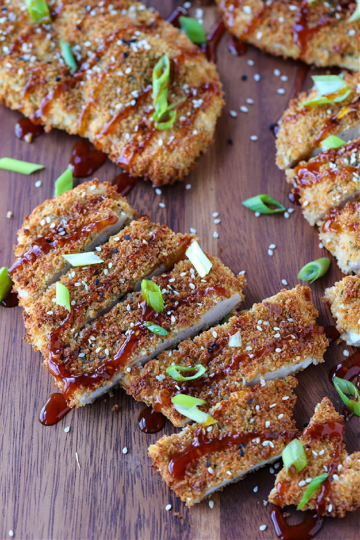 Air Fryer Chicken Katsu tastes as good as the fried version! Slice and drizzle with Asian BBQ sauce (Tonkatsu) and serve on a bed of rice. chicken katsu sliced and drizzled with sauce and scallions