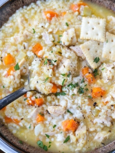 chicken pastina soup in a bowl with spoon