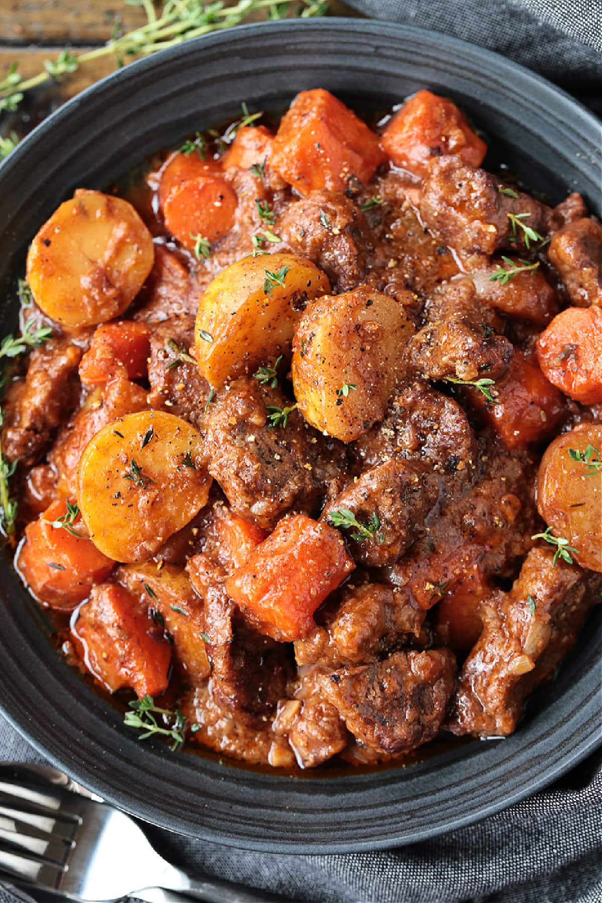 beef stew in a black bowl from the top