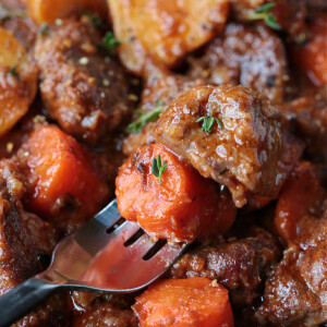 beef stew on fork with carrots and potatoes