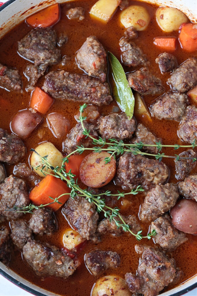 Our Easy Beef Stew is sure to become a family favorite! Tender pieces of beef and vegetables simmered in a red wine and beef gravy. process picture of beef stew ready for simmering