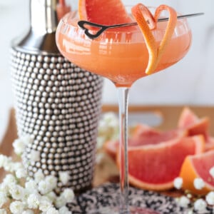 French blonde cocktail in coupe glass with grapefruit garnish