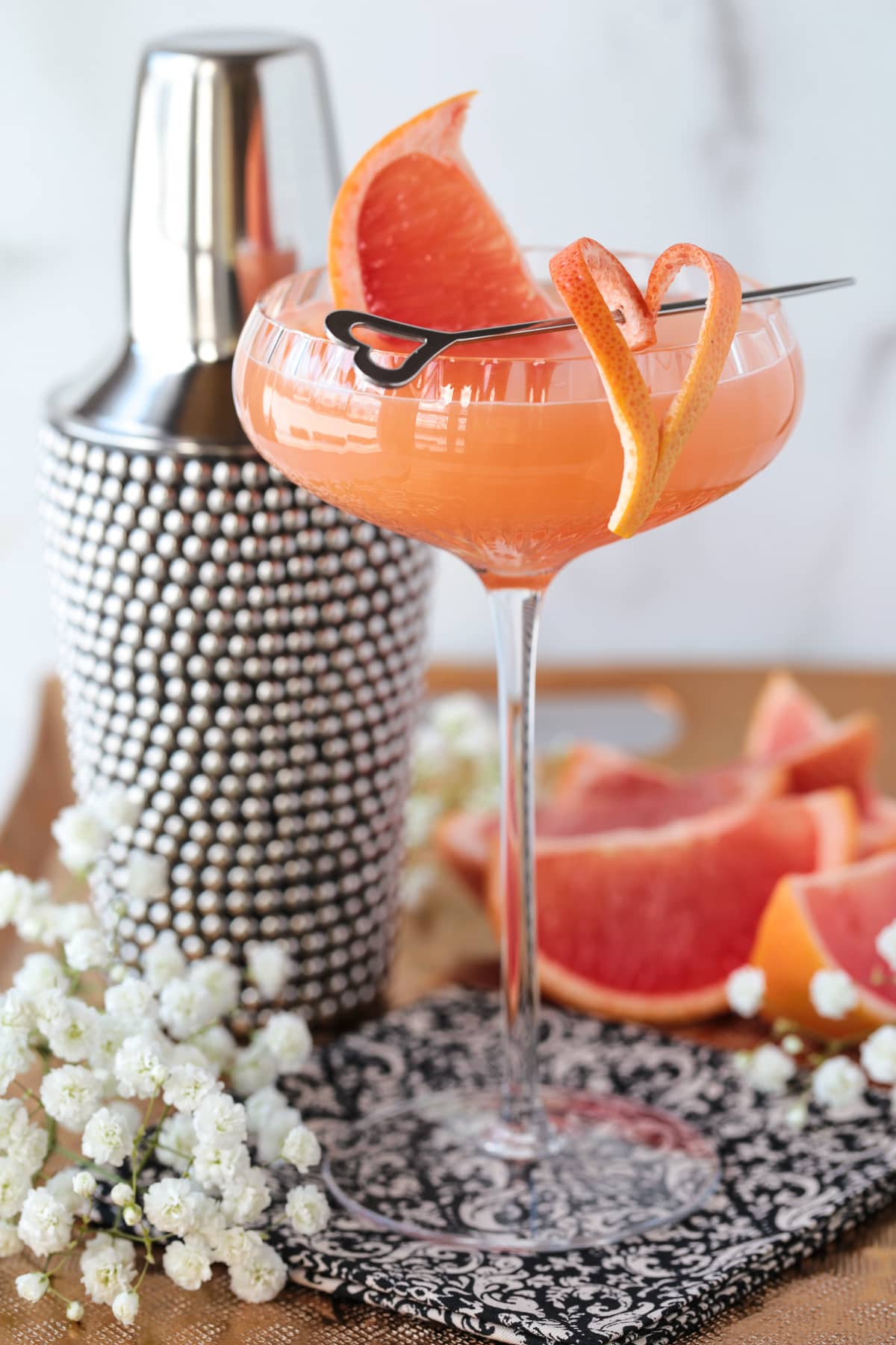 French blonde cocktail in coupe glass with grapefruit garnish