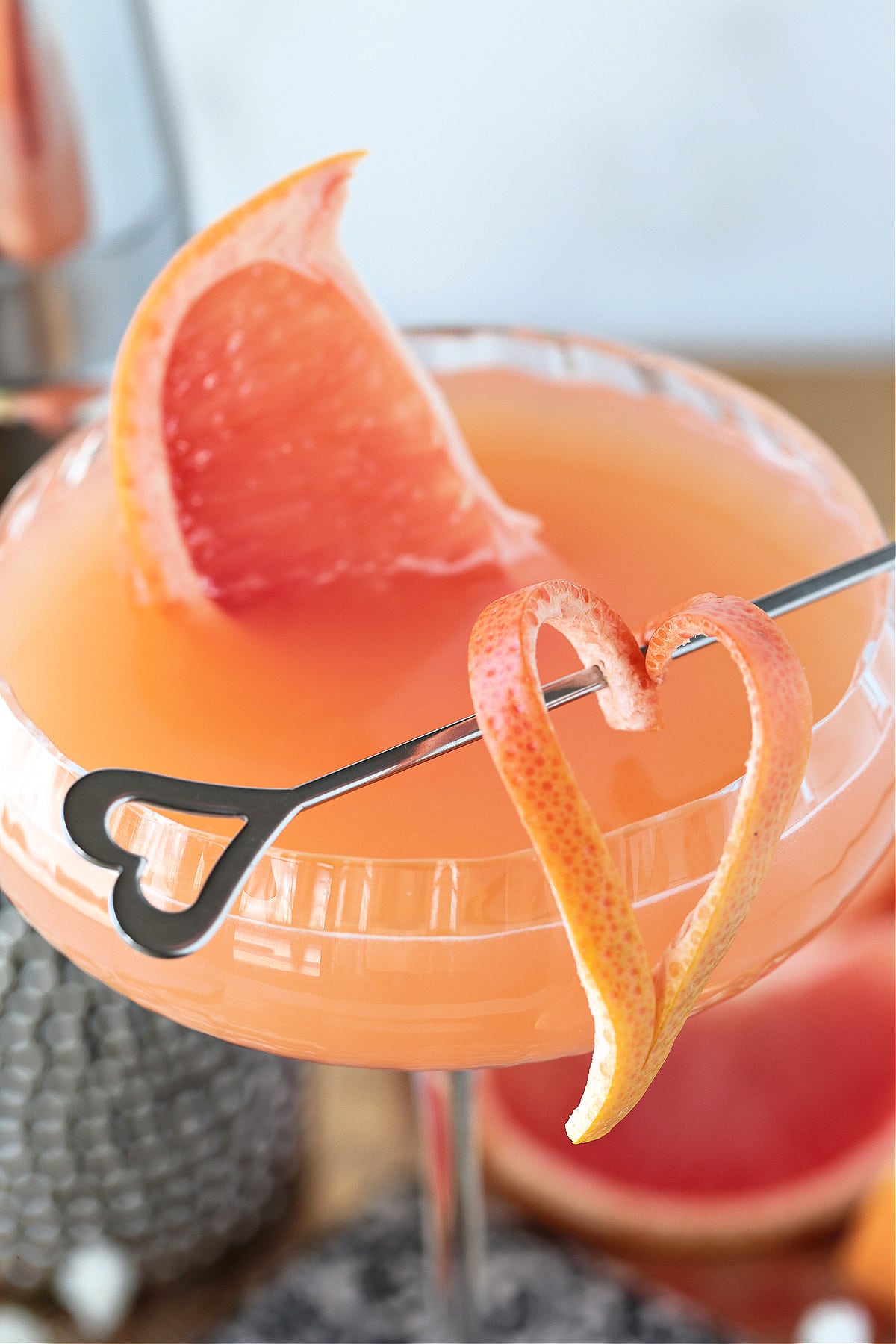 close up of a gin and grapefruit cocktail with grapefruit garnish